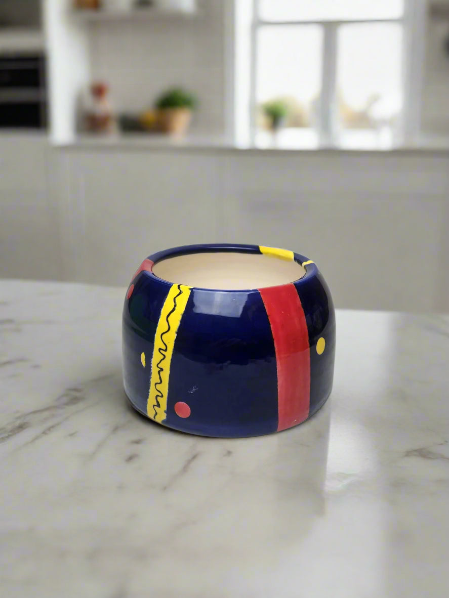 Vibrant hand-painted ceramic cocker spaniel dog bowl with bold, colorful patterns inspired by the Jazz Age. Handmade and one-of-a-kind